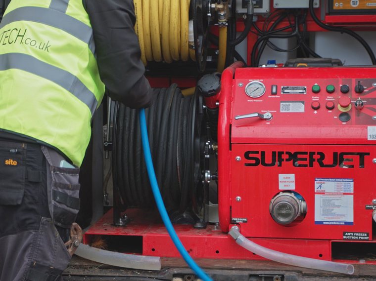 GreaseTech engineer operating a high pressure jetting unit